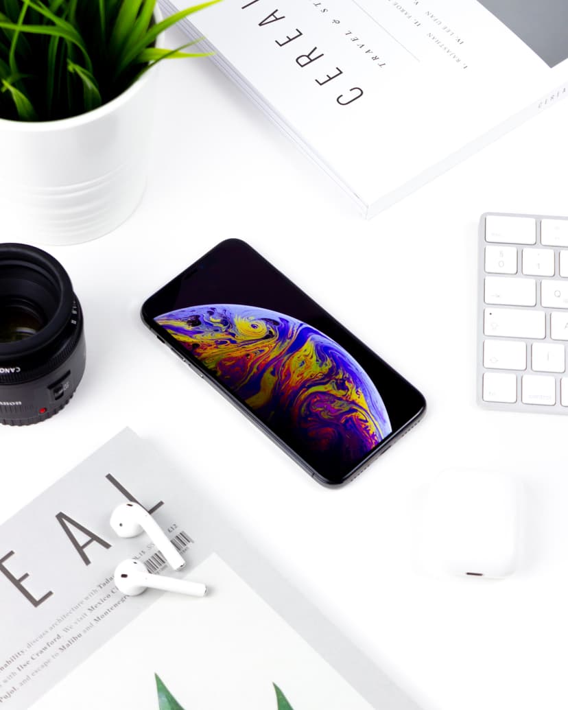 earpod, phone and keyboard on top table